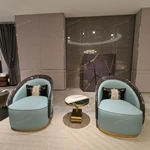Cream Curved Sofa with Diamond-Quilted Backrest, Dark High-Gloss Sides and Teal Accent Panels